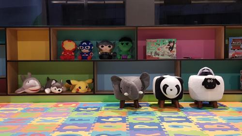 a group of stuffed animals on shelves in a room at Aurico Kata Resort & Spa - SHA Extra Plus in Kata Beach