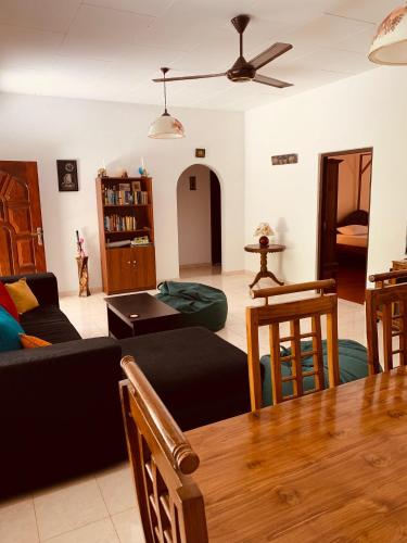 a living room with a couch and a table at Serendipity (Weligama) in Weligama
