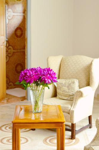 a vase of purple flowers sitting on a table at Rehoboth Mountain Suites in Mbabane
