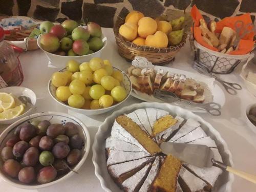 a table topped with bowls of fruits and vegetables at Masseria Scianne in Sant'Isidoro