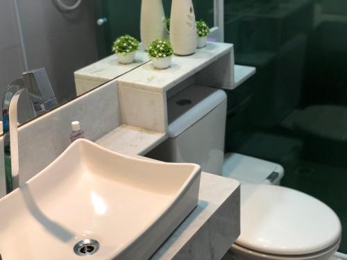a bathroom with a sink and a toilet at Pousada Paraíso Maragogi in Maragogi
