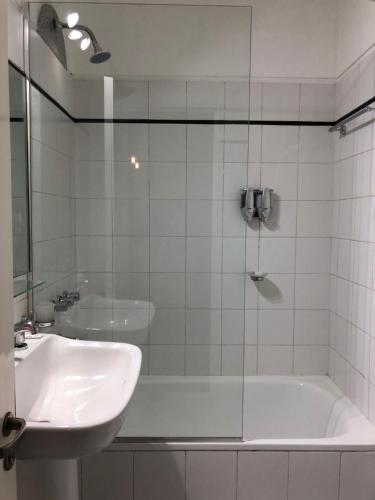 Madero Apartment في بوينس آيرس: حمام مع حوض وحوض استحمام ومغسلة