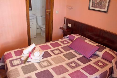 a bedroom with a bed with towels on it at Pension Getariano in Getaria