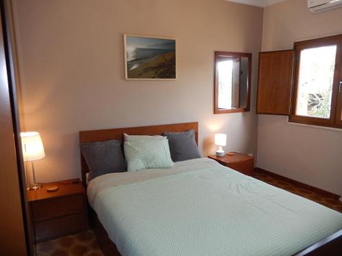 Säng eller sängar i ett rum på Quinta Laranjal da Arrabida