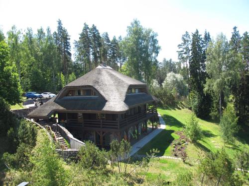 a large house with a gambrel roof at Dzeņi in Amatciems