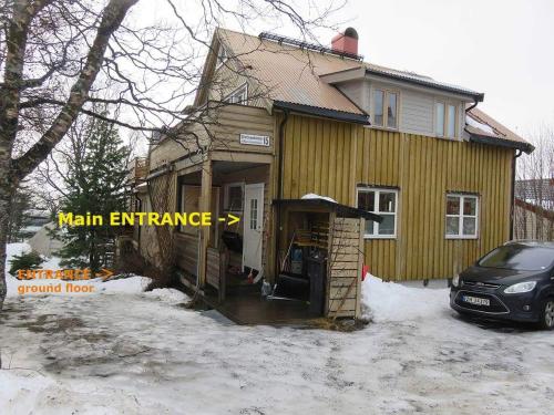 a house with a main entrance with a car parked outside at Beijing home in Tromsø