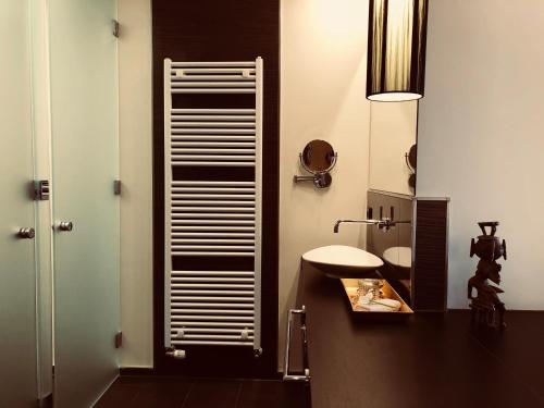 a bathroom with a sink and a toilet in it at Hotel TraumRaum in Heilbronn