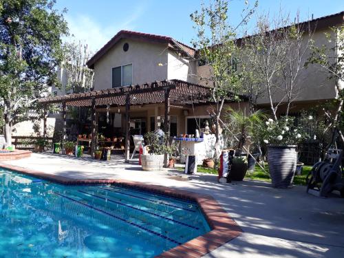 a house with a swimming pool in front of a house at Comfortable Luxury Studio in Los Angeles