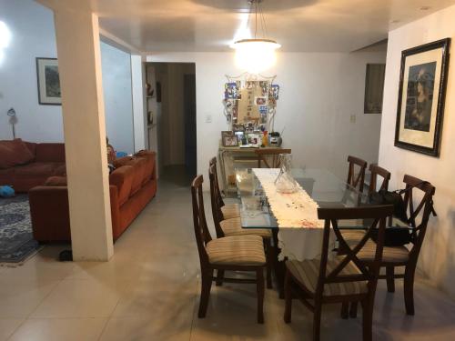 a dining room and living room with a table and chairs at Casa Blumenau in Blumenau
