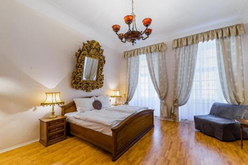 a bedroom with a large bed and a large window at Residence Seven Angels in Prague