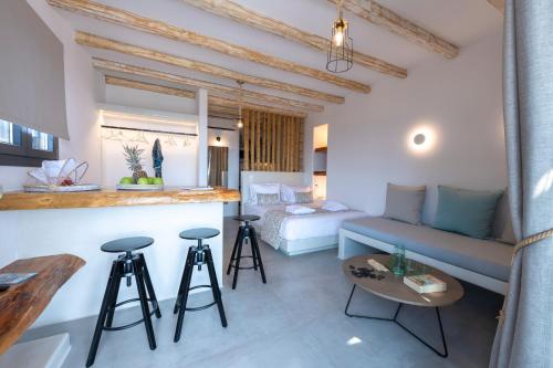 a room with a couch and a bed and a table at Aelia Suites in Adamas