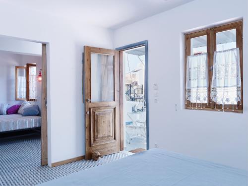 a room with a door and a room with a couch at KALITHEA-HILLS APARTMENT 3 in Koskinou