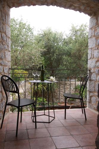 a table and two chairs on a patio at Trapela Areopolis, Boutique Hotel in Areopolis