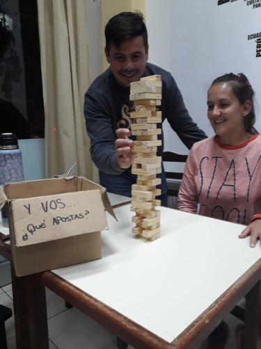 a man and a woman playing with a wooden block tower at Hotel Atlantic in Mar del Plata