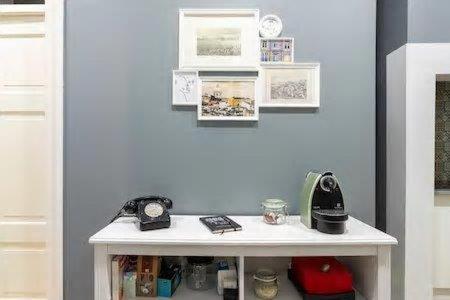 a white table in a room with a wall at Lisbon Charming Apartment in Lisbon