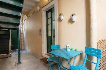 a blue table and two chairs on a porch at Lisbon Charming Apartment in Lisbon
