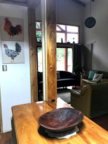 a wooden table with a large rock on top of it at Hostel Isla del Rey in Valdivia