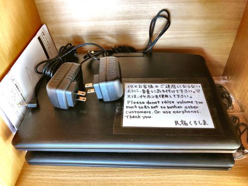 a cake with two cameras on top of a laptop at Minshuku Kuroshima in Kuroshima