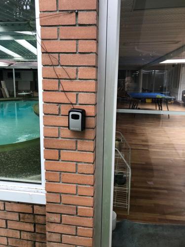 a brick wall next to a swimming pool at Vancouver shaughnessy guest home in Vancouver