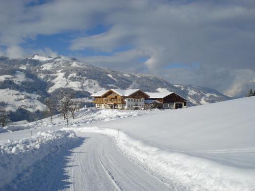a house on top of a snow covered mountain at Mitterbichlhof in Sankt Johann im Pongau