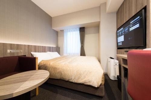 Ein Bett oder Betten in einem Zimmer der Unterkunft Sanco Inn Osaka Yodoyabashi