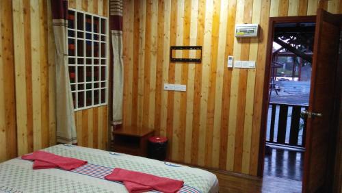 a room with a bed with red towels on it at Chalet Kb Wakaf Kayu in Kota Bharu