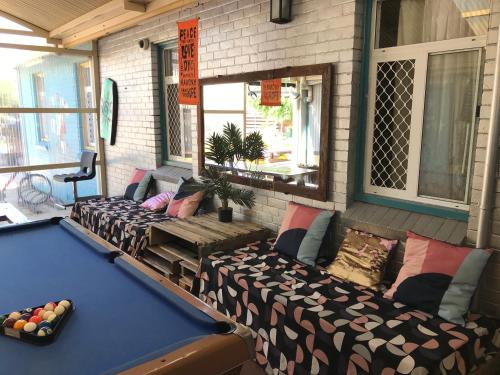 a room with a pool table and a couch at Wander Inn Bunbury in Bunbury