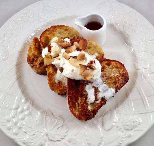 a plate with two pastries with whipped cream and nuts at The Nutmeg Vermont in Wilmington