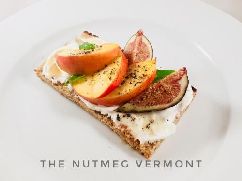 a piece of toast with fruit on a white plate at The Nutmeg Vermont in Wilmington