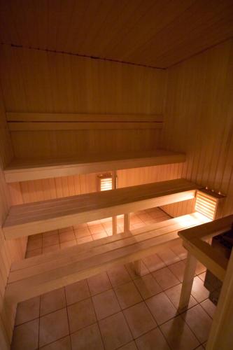 a sauna with a wooden bench in a room at St.Olav Hotel in Tallinn