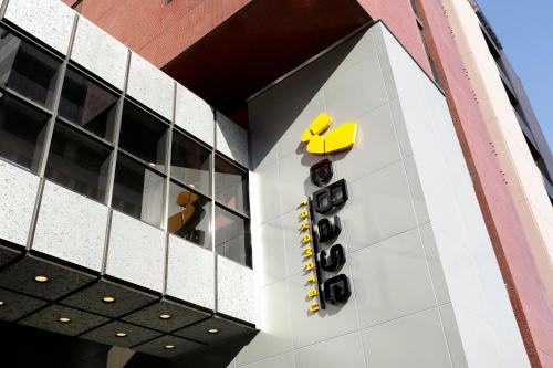 a building with a yellow sign on the side of it at WeBase TAKAMATSU in Takamatsu