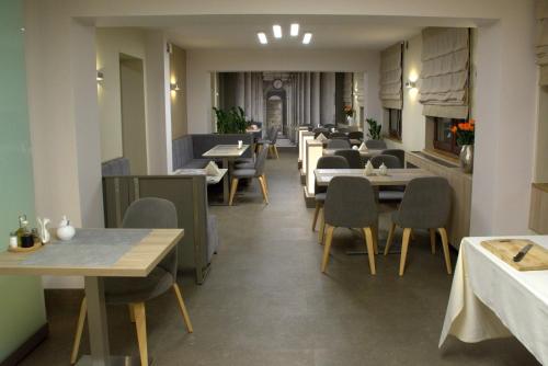 a dining room with tables and chairs and tablesktop at Hotel Pomorski in Bydgoszcz