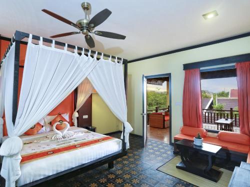 Tempat tidur dalam kamar di Residence Indochine Suite