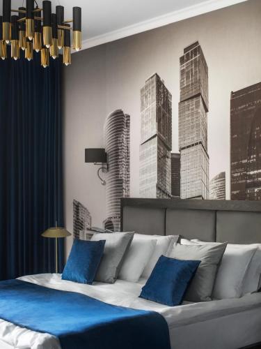 a bedroom with a bed with a mural of skyscrapers at Aqua Perla Boutique Hotel in Chişinău