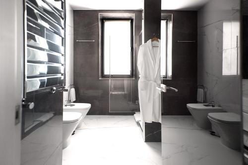 a bathroom with a shower and a toilet and a sink at Aqua Perla Boutique Hotel in Chişinău