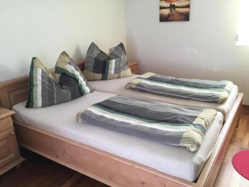 two beds with blankets on them in a room at Haus Ranten 105 in Ranten