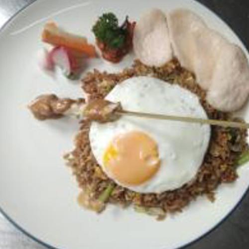 a plate of food with an egg and vegetables at Amalfi Hotel Seminyak in Seminyak