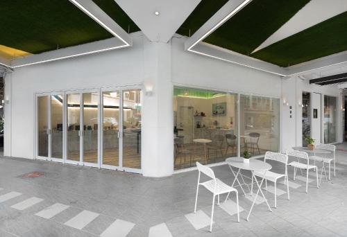 a room with tables and chairs in a building at TG Hostel - stay together in Taichung