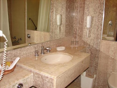 a bathroom with a sink and a mirror at Mansingh Palace, Ajmer in Ajmer