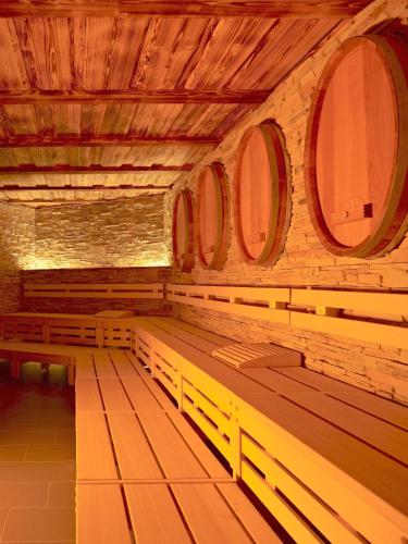 a row of wooden benches in a room with windows at Hotel an der Therme Bad Sulza in Bad Sulza