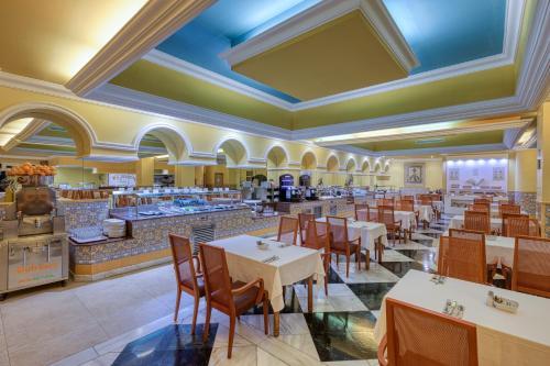 a restaurant with tables and chairs and a counter at Senator Marbella in Marbella