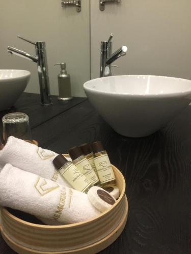 a bathroom with a sink and a towel dispenser at Casa de Campo Memórias da Comarca in Arganil