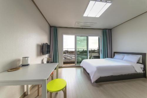 Ένα ή περισσότερα κρεβάτια σε δωμάτιο στο Jeju Soo Pension