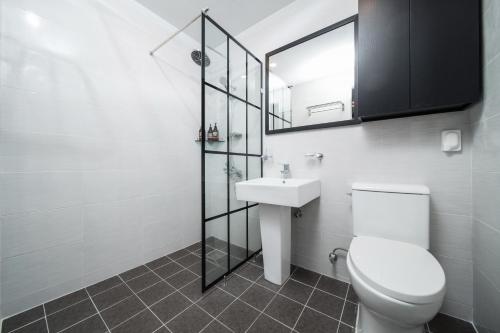 a bathroom with a toilet and a sink and a mirror at Jeju Soo Pension in Seogwipo