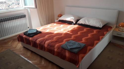 a bedroom with a bed with two towels on it at Dubrovnik Sea View Apartment in Dubrovnik