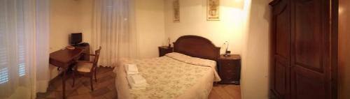 a bedroom with a bed and a dresser in it at Il Portico in Carrosio