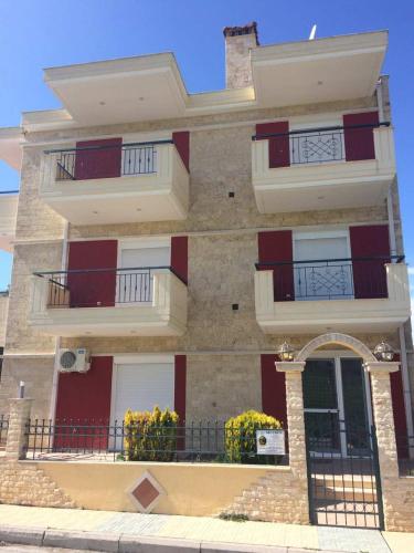 a building with red and white balconies on it at SONIA in Kallithea Halkidikis