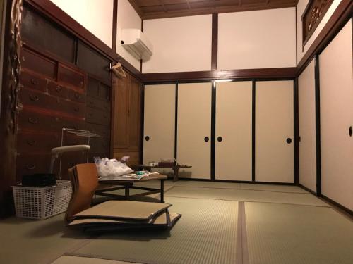 a room with sliding doors and a chair and a table at Traveler's Wharf Shichigahama in Shichigahama