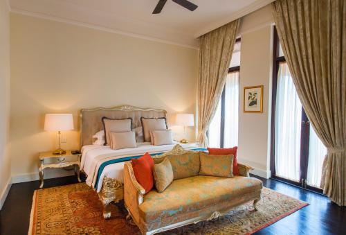 
a bedroom with a large bed and a large window at Galle Face Hotel in Colombo
