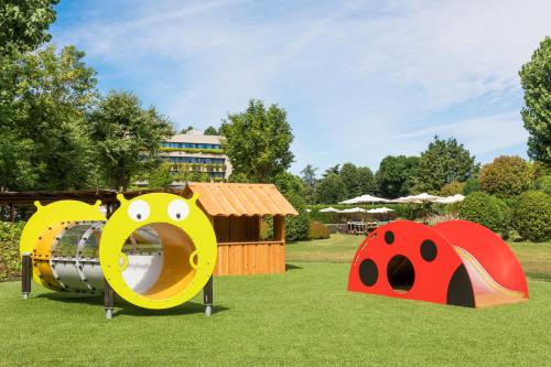 a playground with different types of play equipment in a park at Casa Bianca Apartments in Como